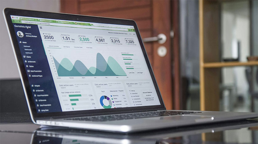 A laptop showing finance graphs