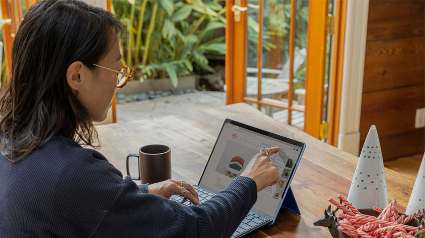 A woman sat at her laptop, going through her finances